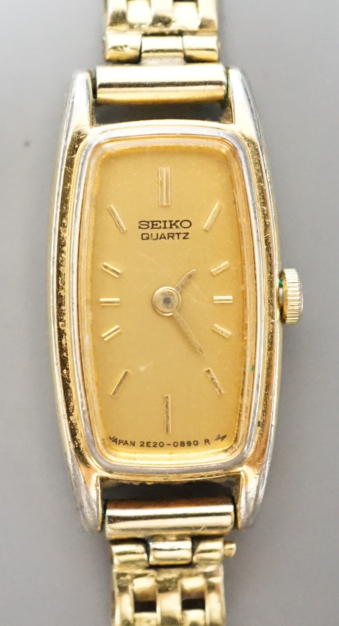 A lady's steel and gold plated Seiko quartz wrist watch, on an 18ct gold bracelet